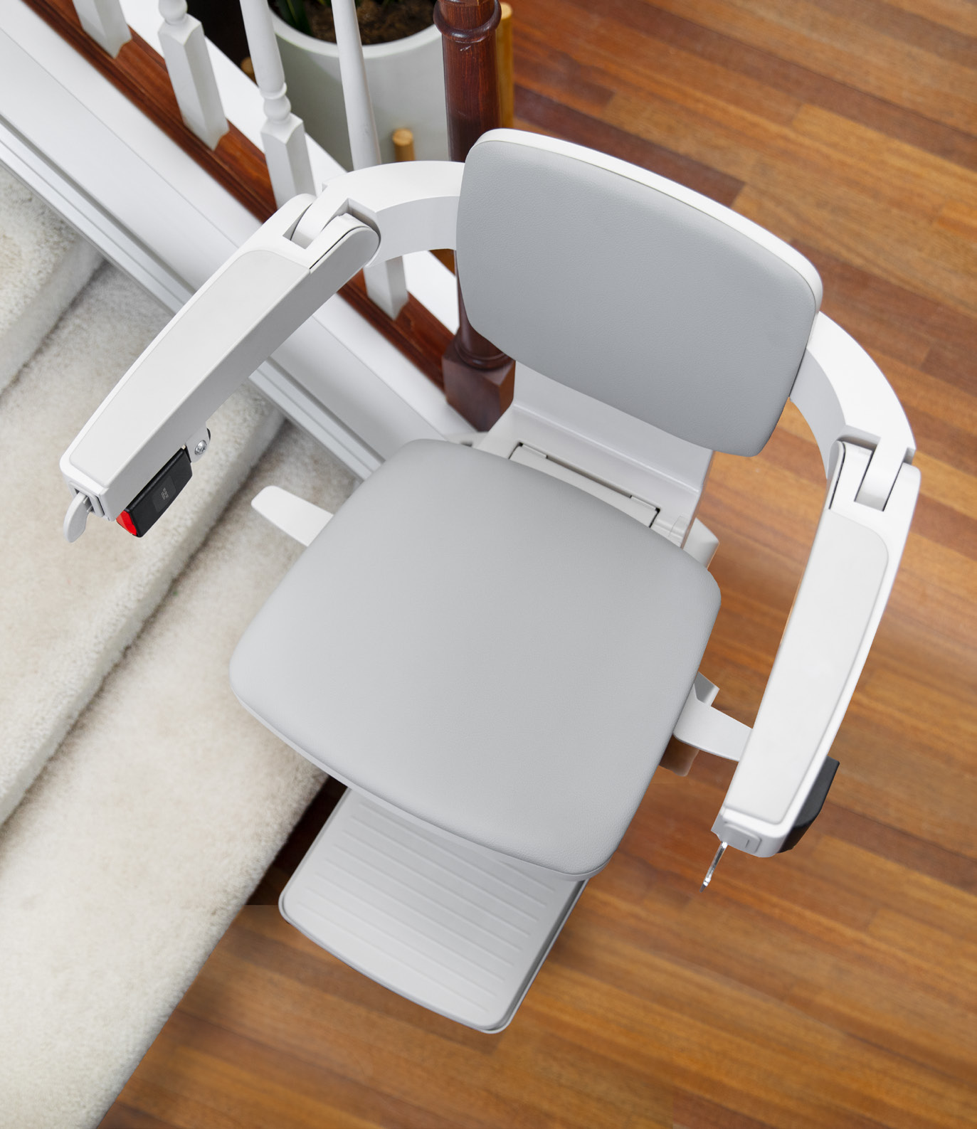 Close-up of the Bruno Elan stair lift's folded seat, armrests, and footrest showing its compact profile